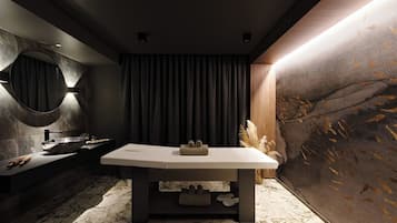 A modern bathroom with a marble floor, a central table with towels, a round mirror, and a large textured wall.