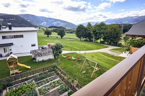 A residential area with a view of mountains, a playground, and a garden. - Apartment 'Huberhof - Puschtra' (Santo Stefano)