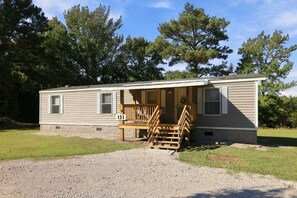 A single-story mobile home with a porch and a number '51' sign. - A Cozy Place - Country/Beach Living (Beaufort)