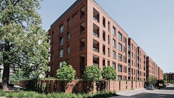 A red brick building with multiple floors and large windows.