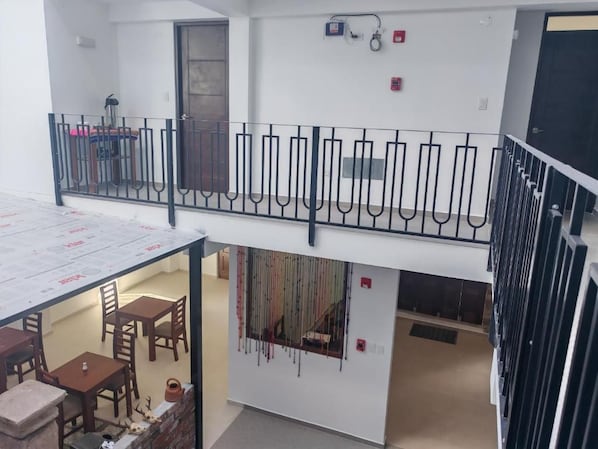 A multi-level interior with a balcony, a dining area, and a staircase. - CASA DREAMS CUSCO (Cusco)