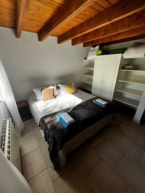 A bedroom with a bed, a wardrobe, and a radiator. - VF Catedral Mountain Department (San Carlos de Bariloche)