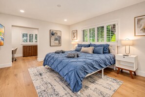 A bedroom with a bed, a bedside table, a desk, and a chair. - Private Oasis 5 Bed 4 Bth w Heated Pool Great for Families and Large Groups (Miami)