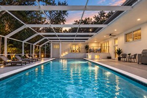 A swimming pool with a covered area, lounge chairs, and a grill. - Private Oasis 5 Bed 4 Bth w Heated Pool Great for Families and Large Groups (Miami)