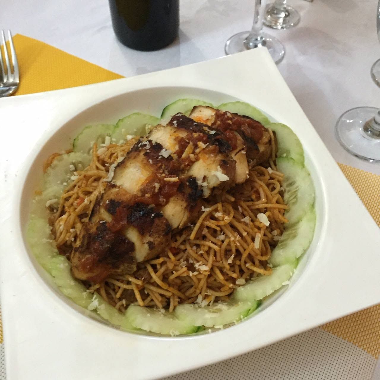 Un plato de comida con fideos, carne y verduras.