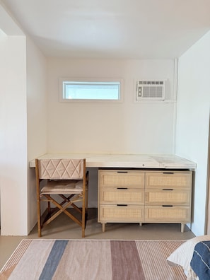 A room with a desk, a chair, a window, and a radiator. - Cozy 1-bedroom apartment in peaceful Casuarina with AC (Casuarina)
