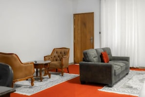 A room with a sofa, armchair, and a small table. - GRANADA HOTEL NAIROBI  (Westlands)