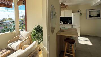 Un appartement moderne doté d’un balcon, d’un coin repas et d’une cuisine.
