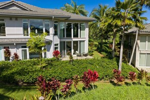 A modern two-story house with a large front lawn, palm trees, and a well-maintained garden. - Haven Villa by Gather - 3BR Princeville Townhome w/ Anini Valley Views (Princeville)