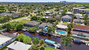 A residential area with houses, a swimming pool, and a dock. - Pool Home - Close to Barefoot & Bonita Beaches (Bonita Springs)