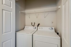 A laundry room with two white washing machines and a drying rack. -  Long Stays; King Bed 2BDR/2BA Suite; Private Garage (Roseville)