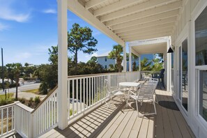 A covered outdoor area with a white railing, a table, and chairs. - Gulf View, Great Location, Pool, Hot Tub, Tennis (Santa Rosa Beach)