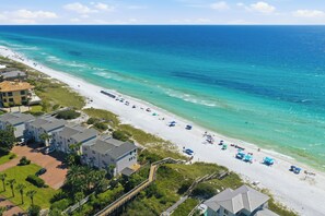 A beach resort with multiple buildings, a sandy beach, and a clear blue ocean. - Gulf View, Great Location, Pool, Hot Tub, Tennis (Santa Rosa Beach)