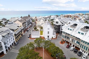 A coastal town with a central white building, narrow streets, and parked cars. - Serenity by the Sea 30A (Panama City Beach)