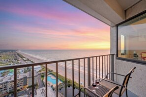 A balcony with a view of a beach and a swimming pool. - Myrtle Bch Renaissance 2107-Ocean View Efficiency (Myrtle Beach)