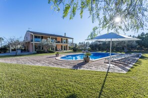 A two-story house with a swimming pool, a covered patio, and a well-maintained lawn. - Villa 'Verdura' with Mountain View, Wi-Fi and Air Conditioning (Inca)