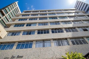 A multi-story building with a modern architectural style, featuring a series of windows and a textured facade. - Apt. in Condo. w/ BBQ & Sea View Bvm0510 (Recife)