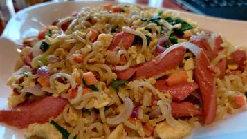 A plate of stir-fried noodles with vegetables and meat.