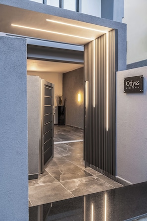 A modern entrance with a metal gate, a sign reading 'Odysss Residence', and a wall-mounted light fixture. - Odyss Residence Ioannina (Ioannina)