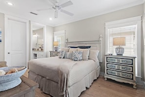 A bedroom with a bed, dresser, and a ceiling fan. - St. Somewhere (Panama City Beach)