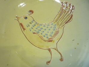 A ceramic plate with a bird design.