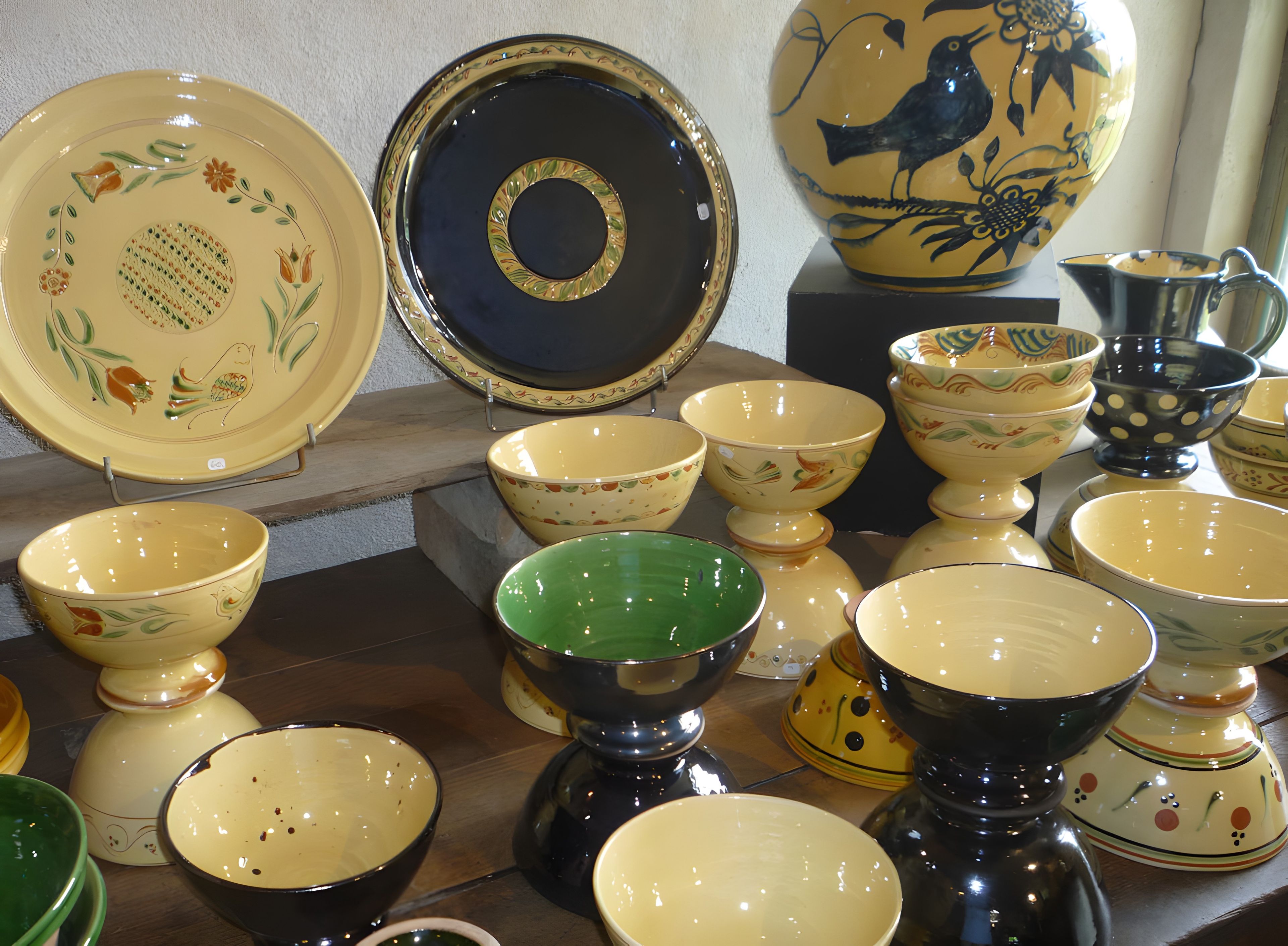 A collection of ceramic bowls and plates with various patterns and colors.