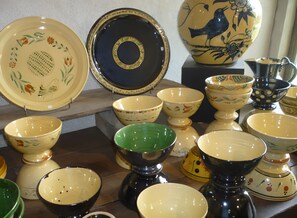 A collection of ceramic bowls and plates with various patterns and colors.