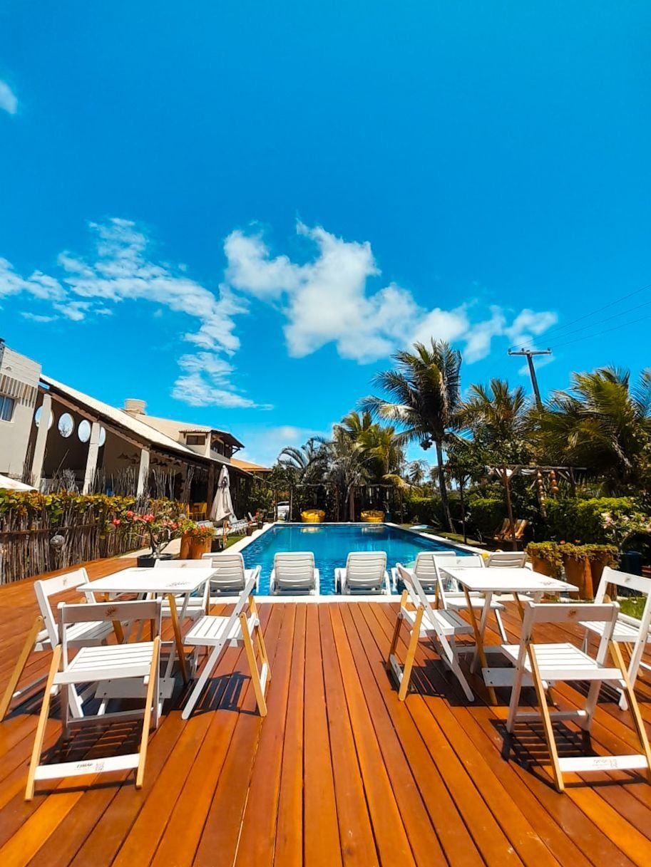A poolside area with lounge chairs and a wooden deck.