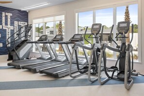 A gym with treadmills, a stationary bike, and a rowing machine. - Landing Spectacular 1BD in Clara Avenue (Panama City Beach)