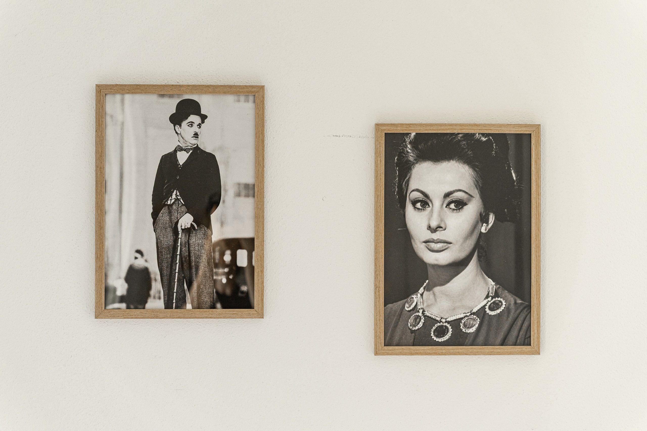 Two framed photographs on a wall.
