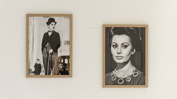 Two framed photographs on a wall.