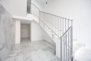 A staircase with a metal railing leading to an upper floor. - Casa Azahar · Beautiful apartment in Villamartín (Orihuela Costa)