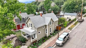 A residential area with houses, a driveway, and a parked car.
