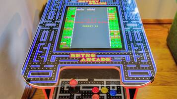 A retro arcade machine with a screen displaying game options and a joystick control panel.