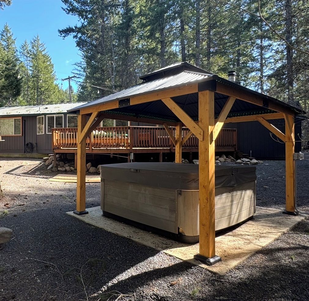 Private covered hot tub in a peaceful forest cabin setting