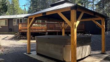 Private covered hot tub in a peaceful forest cabin setting