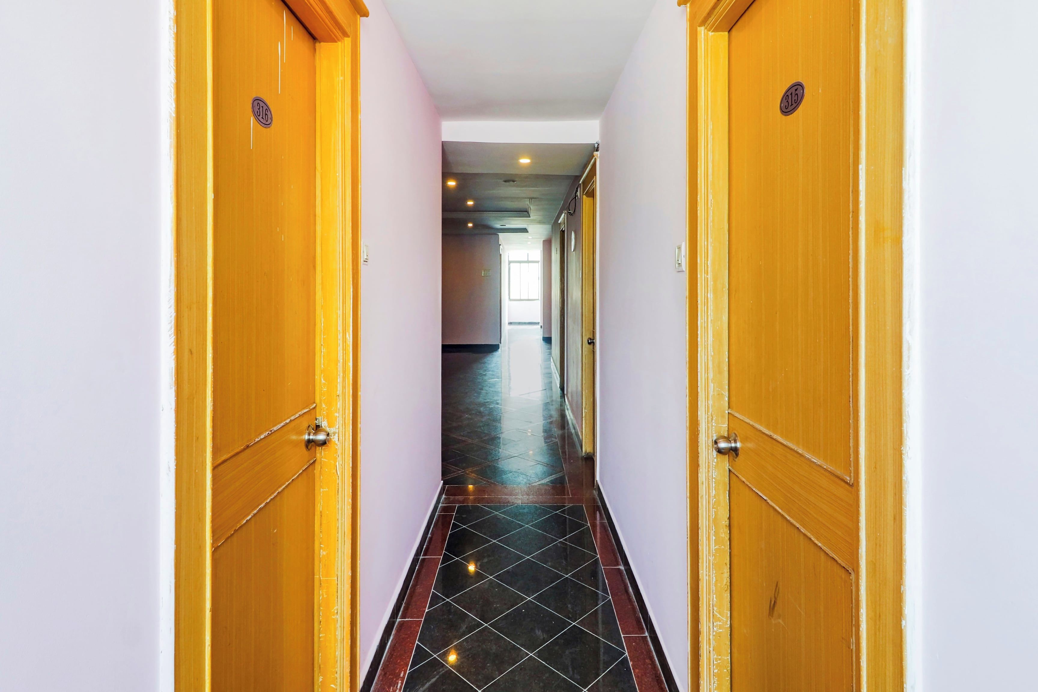 A hallway with wooden doors, each marked with a number.