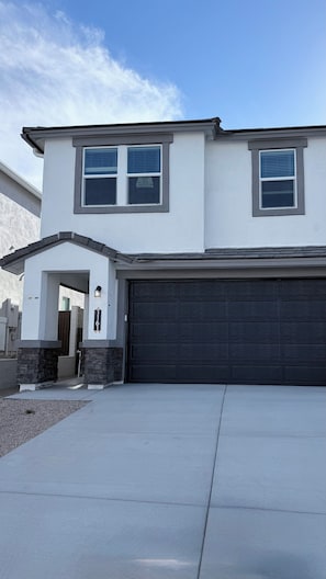 A two-story house with a garage, a driveway, and a small entrance porch. - South Mountain 4 bedroom luxury retreat (Phoenix)