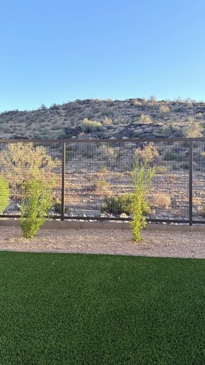 A fenced area with a rocky hillside in the background. - South Mountain 4 bedroom luxury retreat (Phoenix)