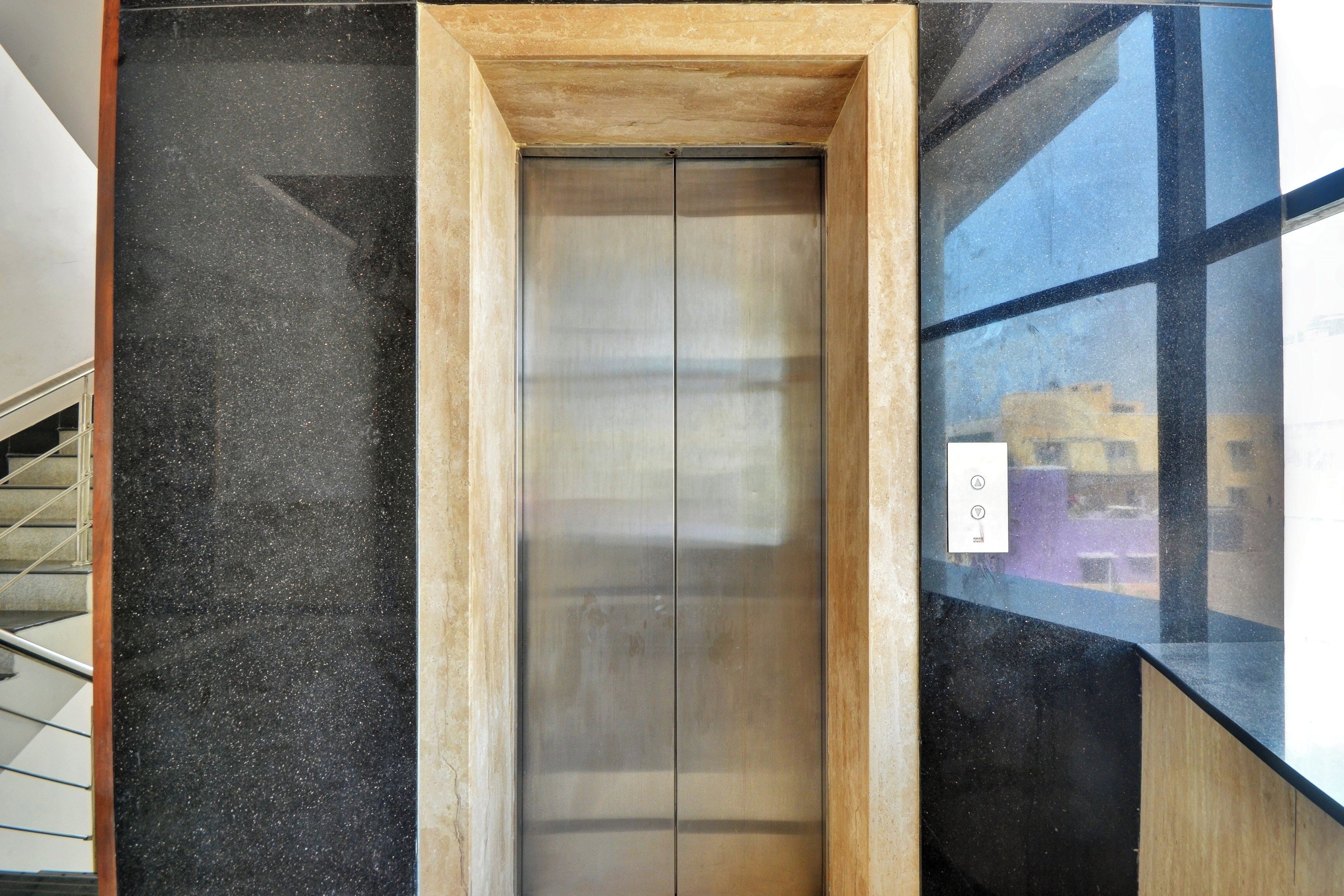 An elevator with a wooden frame and a glass panel on one side.