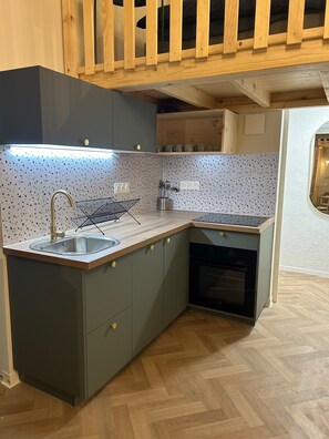 A compact kitchen with a built-in oven, a sink, and a wooden countertop. - The Alsatian Inn - 14 guests (Strasbourg)
