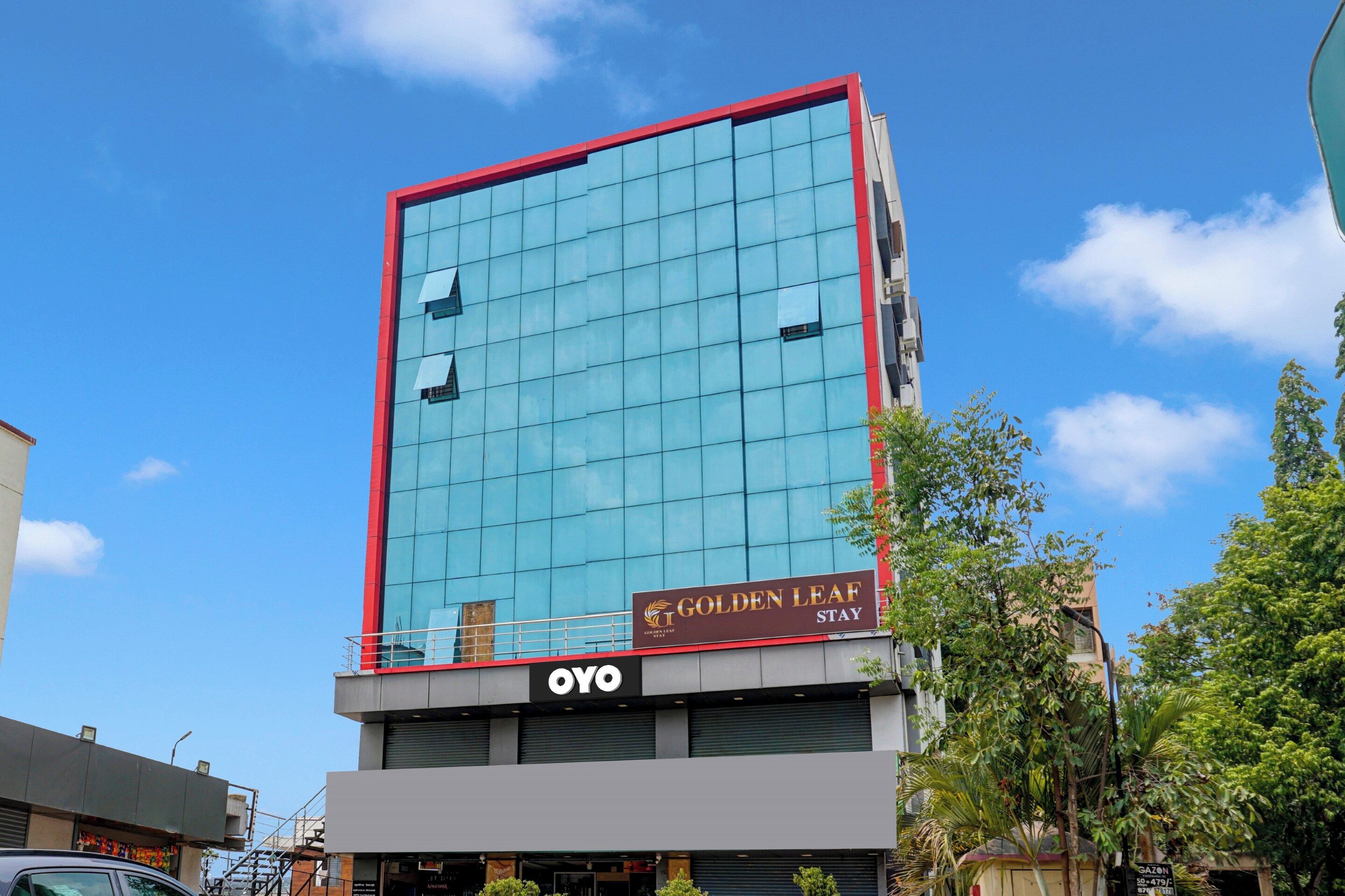 A modern building with a glass facade and a red frame.