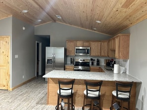A modern kitchen with wooden cabinets, stainless steel appliances, and a granite countertop. - Arkansas Cabin

Wonderful 3-bedroom triplex in charming Kirby next to the lake. (Kirby)