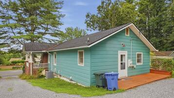A small, single-story house with a porch, a front door, and a small front yard.