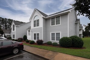 A two-story residential building with a symmetrical facade, multiple windows, and a central entrance. - 1 bedroom Apartment 10 min from ECU (Greenville)