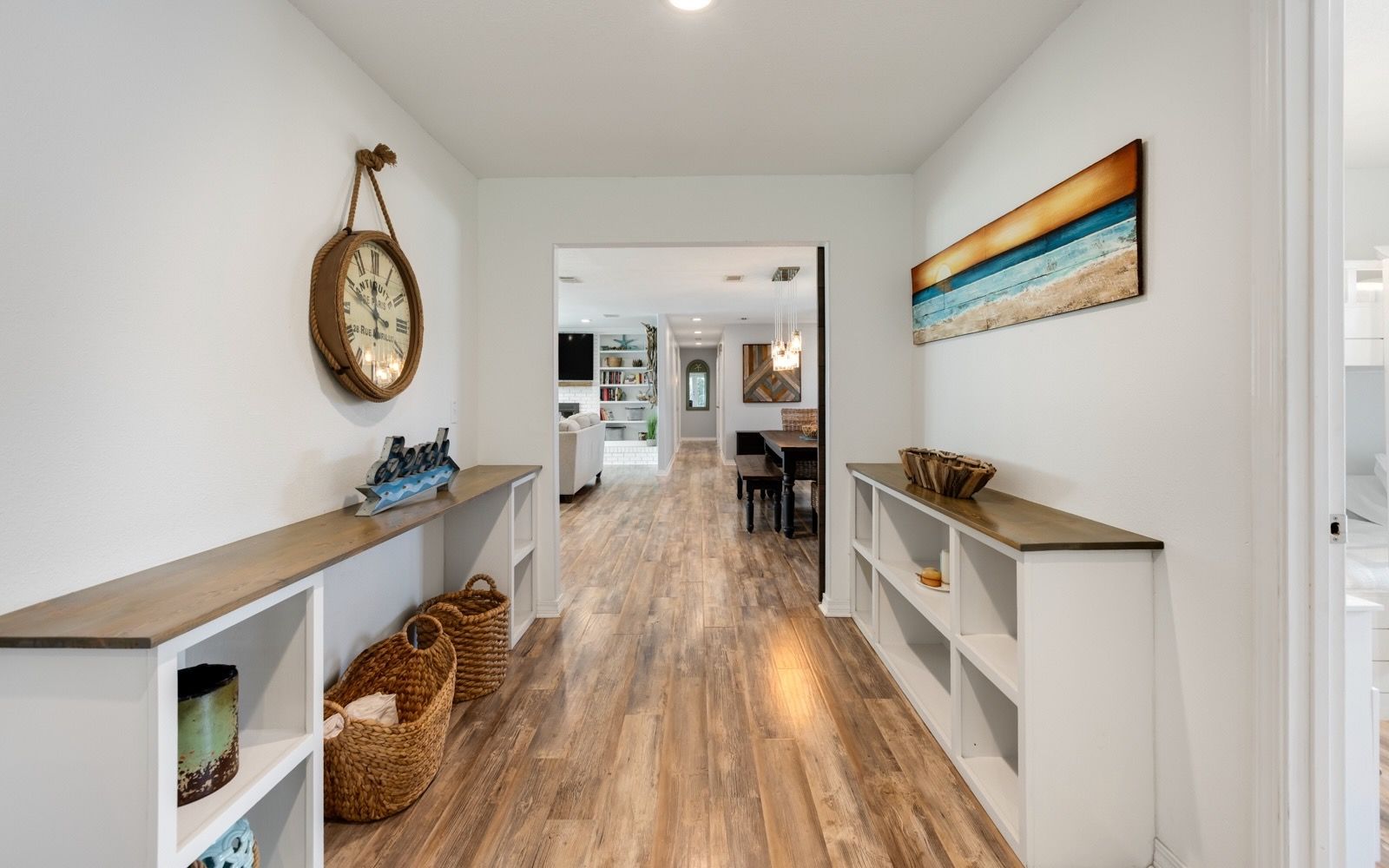 Follow the hallway toward the heart of the home, where shared spaces and vacation memories await.