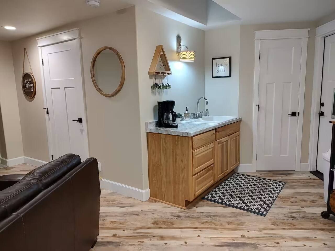 A modern kitchen with wooden cabinets, a built-in sink, and a coffee maker.