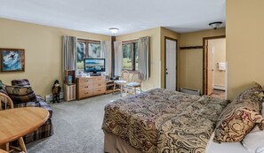 A bedroom with a bed, a television, a desk, and a chair. - Kettlebrook Ski-In/Ski-Out Condo with Fireplace (Ludlow)