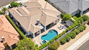 A residential property with a swimming pool, multiple roof styles, and a landscaped garden. - Desert Dreamin' with Private Pool & Spa (Palm Desert)