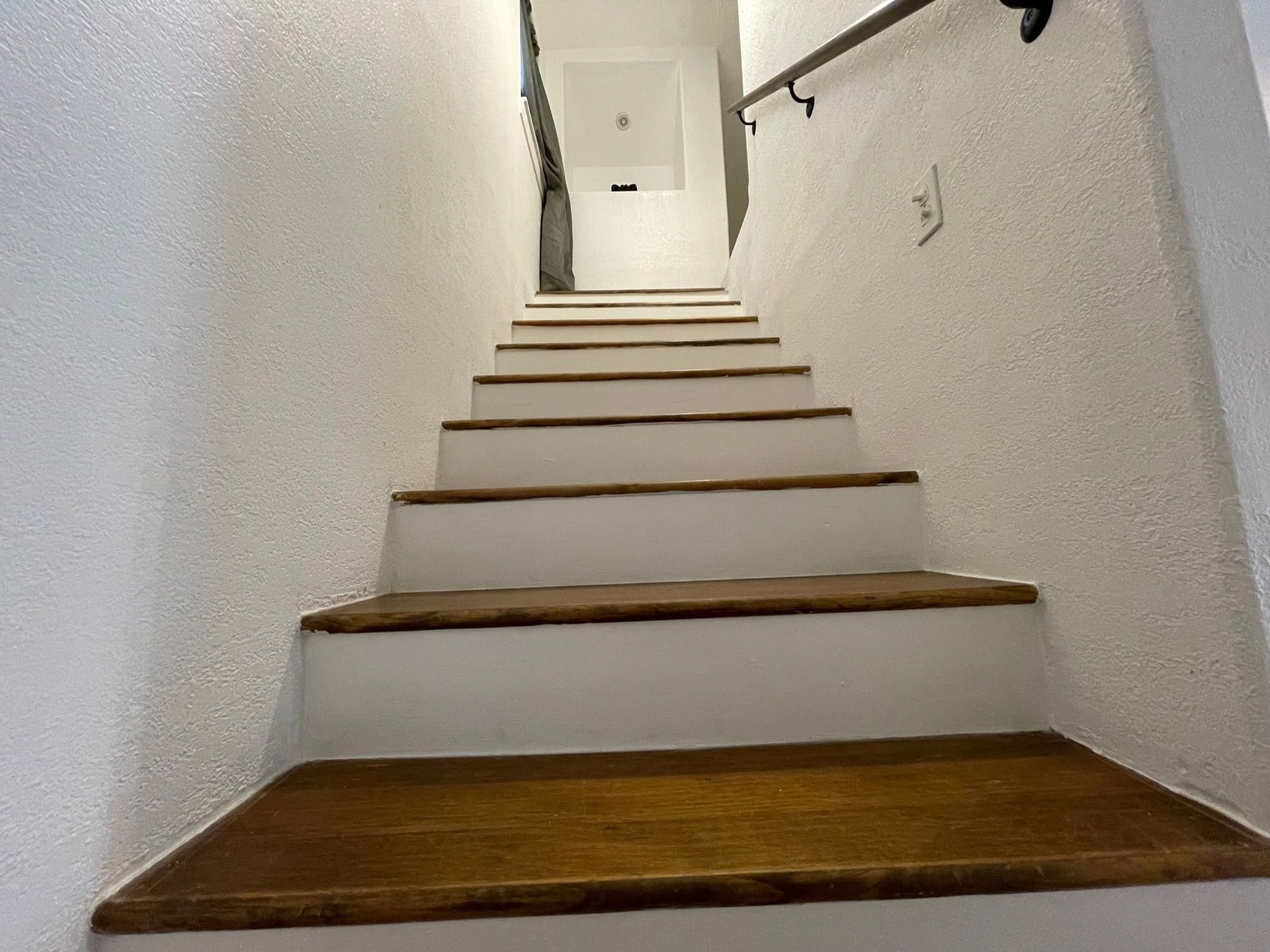A staircase with wooden steps leading to a landing.
